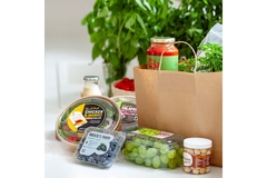 Image A group of groceries spilling out of a paper bag.